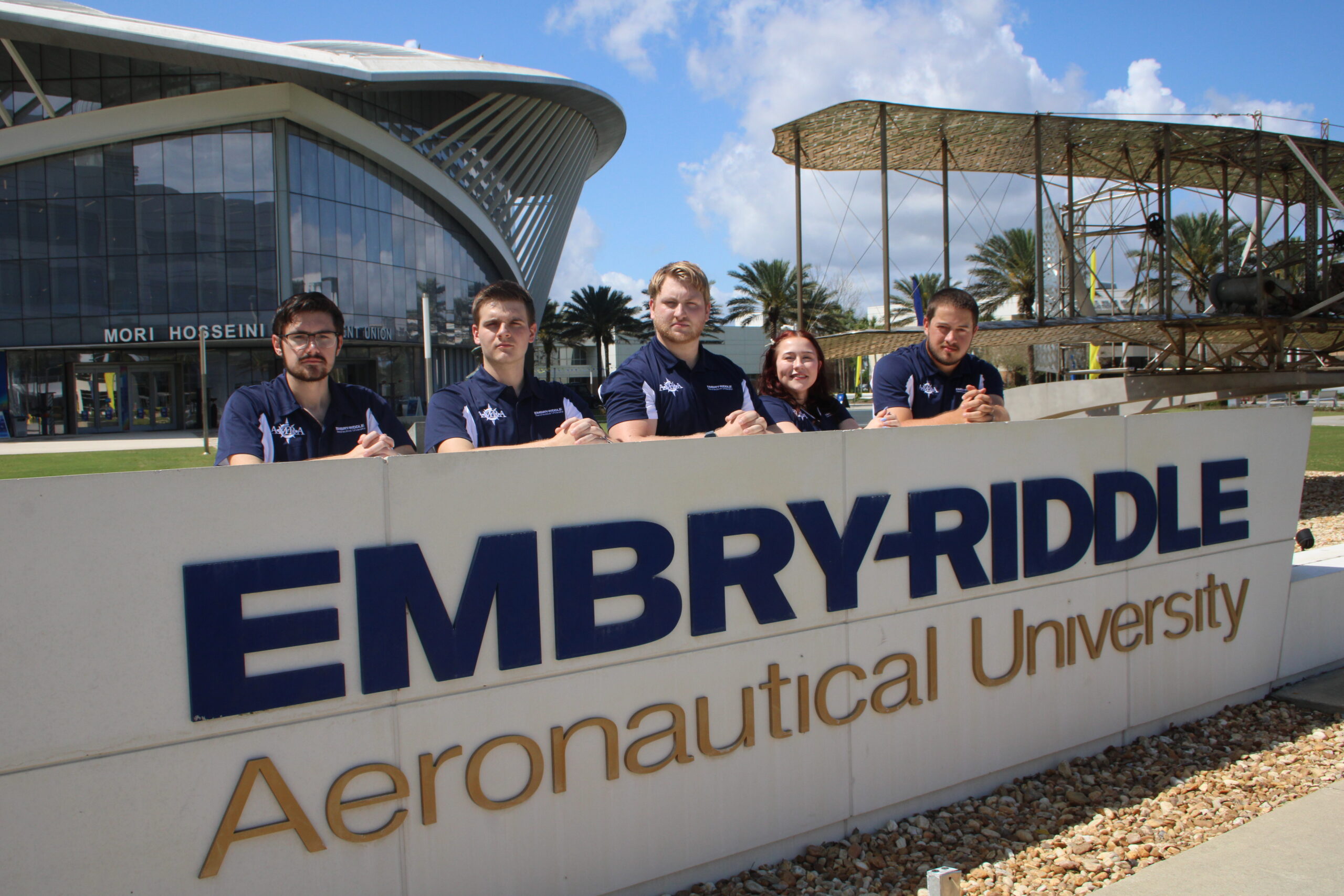 Group photo of AMRA executive board behind Embry-Riddle sign.